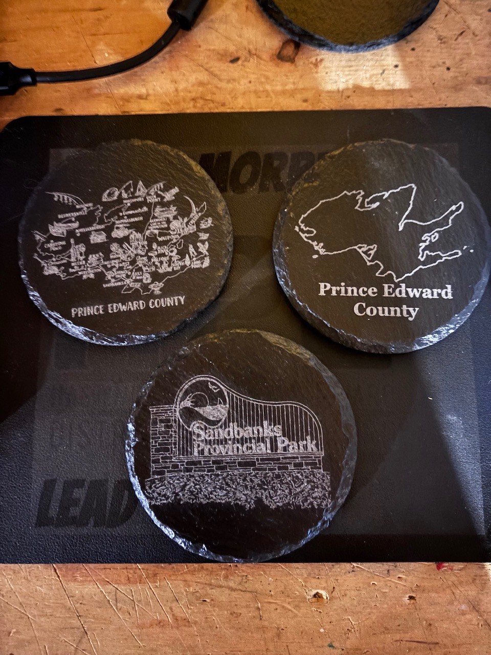 Slate coasters celebrating Prince Edward County and Sandbanks